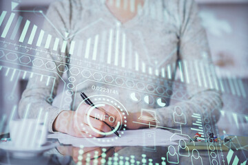 Technology theme hologram over woman's hands taking notes background. Concept of Tech. Double exposure