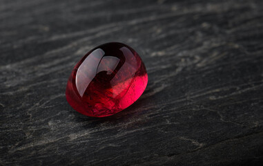 Red ruby gemstone with dark rock.