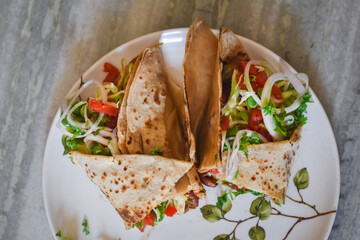 Tortilla wrap sandwiches with mexican beans and vegetables in dish