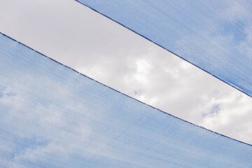 Fototapeta na wymiar Blue cloth over cloudy sky