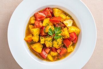 Colorful summer salad with tomato and peach, close up. Top view.