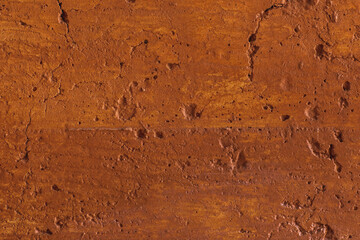 Traditional moroccan terracotta colored background. Orange or ocher clay wall texture. Painted shabby concrete.