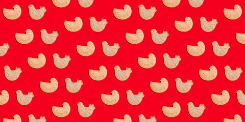 Christmas background. Gingerbread cookies in the form of birds on a red background.