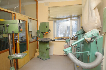 Belt grinding machine, vertical band saw, pillar drill machine set in workshop for manufacturing...
