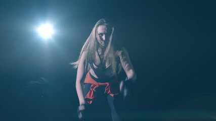 Beautiful muscular woman exercising on a rope in gym. Functional training. Motivation. Success concept. Crossfit Focus. Filmed on Cinema Camera in 4K. Professional cinema lighting.