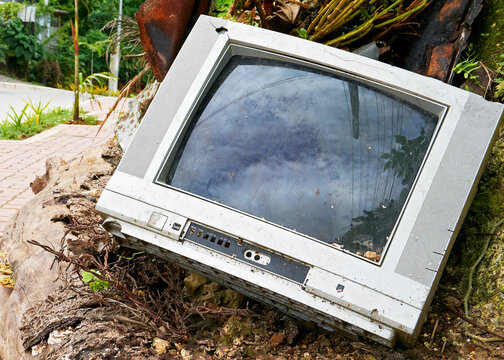 Old,  broken analog television set dumped along the roadside by an irresponsible consumer in Asia 