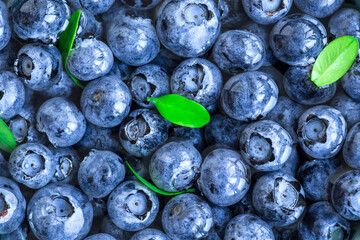 Blueberries floating in water with bubbles. Fresh blueberries background with copy space for your text. Vegan and vegetarian concept.Texture blueberry berries close up