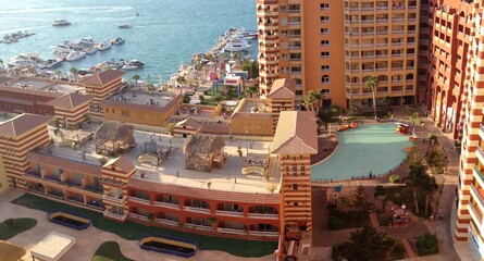 sea view of yacht harbor with swimming pools and residential resort facing lagoon