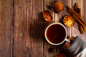 Autumn flat lay composition with tea cup and autumn dried fruits and leaves