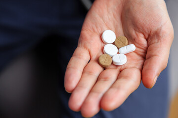 A handful of pills in hand