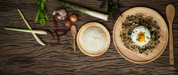 Stir-fried meat with bamboo shoot and holy basil served with steamed rice fried egg