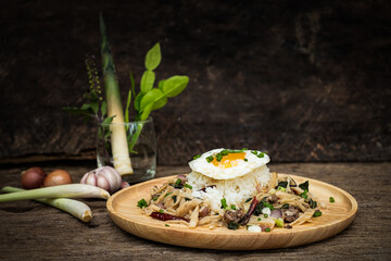 Stir-fried meat with bamboo shoot and holy basil served with steamed rice fried egg