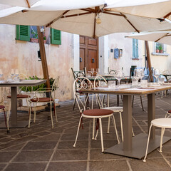 outdoor cafe with tables, chairs and beach umbrellas
