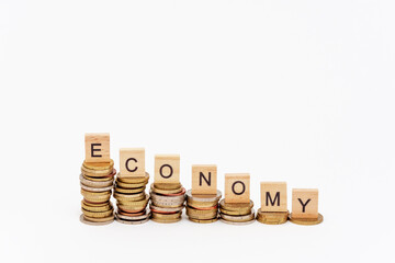 Lettres en bois posées sur des piles de pièces de monnaies de hauteurs décroissantes et...