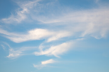 Blue sky background with light wight cirrus clouds.