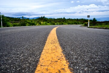 The yellow center line on asphalt car road in Japan.
