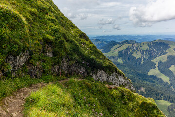 Naklejka premium The steep path leading to the majestic Schaefler peak in the Alpstein mountain range around the Aescher cliff in Appenzell, Switzerland