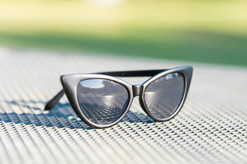 Fototapeta na wymiar Cat eye sunglasses black model shoot in a summer day closeup. Selective focus