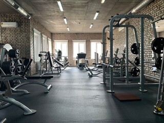 Gym for bodybuilding. Heavy dumbbells and exercise equipment. Barbells and equipment for athletes.