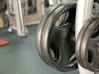 Gym for bodybuilding. Heavy dumbbells and exercise equipment. Barbells and equipment for athletes.
