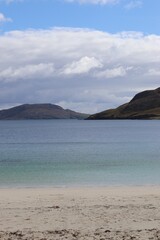 lake and mountains, vatersay beach, hebrides, scotland