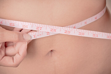 women Slim waist with a tape measure around it
