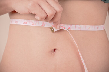 women Slim waist with a tape measure around it