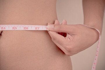 women Slim waist with a tape measure around it