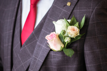 Wedding. Wedding rose boutonniere close-up on the groom's jacket