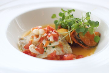 Close up of a plate of delicious grilled fish served with pumpkin and potato sauce, Japan, soft...