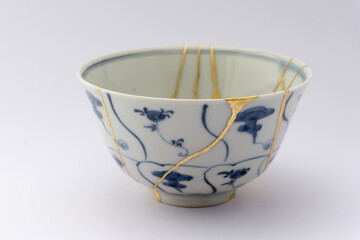 Kintsugi blue and white tea ceremony chawan tea bowl. Gold cracks restoration on old Japanese pottery restored with the antique Kintsugi restoration technique. The beauty of imperfections. 