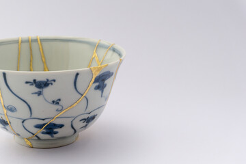 Kintsugi blue and white tea ceremony chawan tea bowl. Gold cracks restoration on old Japanese pottery restored with the antique Kintsugi restoration technique. The beauty of imperfections. 