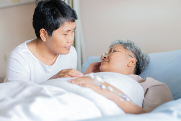 Love hope concept: Happy partner couple Visits lover holding hand for recovering that sick lying on bed in Hospital, Patient smiling with happy when get support from family,looking hopeful emotional
