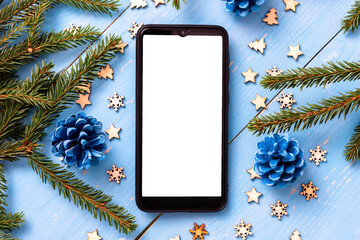Phone on the table at Christmas with Christmas trees.