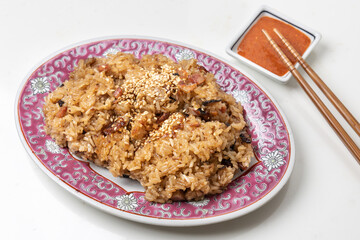 Traditional Chinese glutinous rice with pork, sausage, mushroom and sesame with chili sauce as dipping.