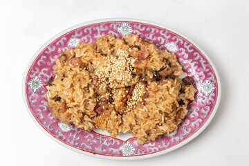 Traditional Chinese glutinous rice with pork, sausage, mushroom and sesame.