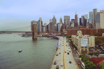 High view from Manhattan Bridge over Brooklyn Bridge and Manhattan skyline