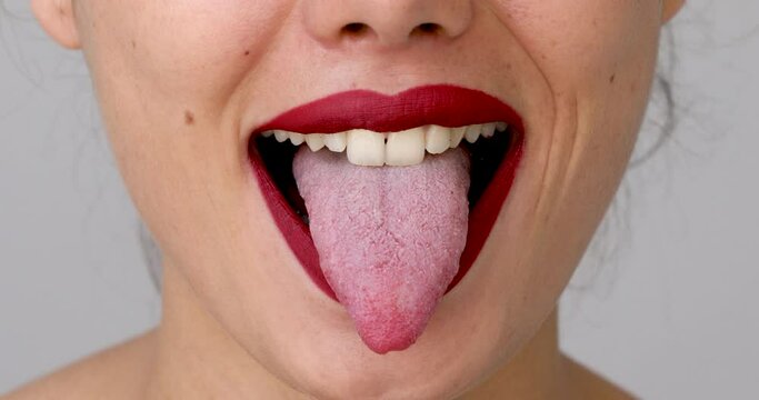 Close up view woman showing tongue