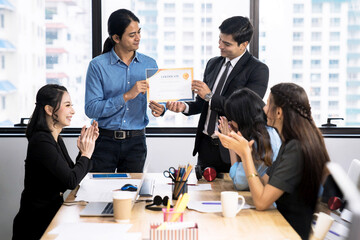 Business executives congratulate employees on their excellent work, Certificate of Excellence or a...