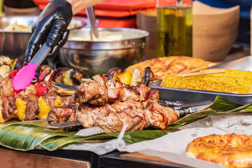 Culinary buffet with a presentation of a variety of healthy food - meat, sausage, grilled vegetables. Kitchen in the open air.