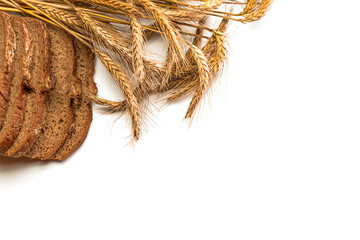Freshly baked bread. Fresh loaf of rustic traditional bread with wheat grain ear or spike plant isolated on white background. Rye bakery with crusty loaves and crumbs. Healthy Food concept.