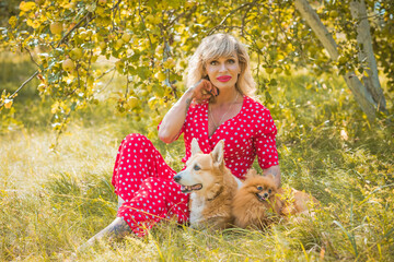 Mature women lifestyle with her pets, American tan lady stylish dressed, posing outdoor, other beauty
