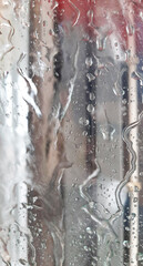 View from the car on the glass with drops and a brush in a car wash