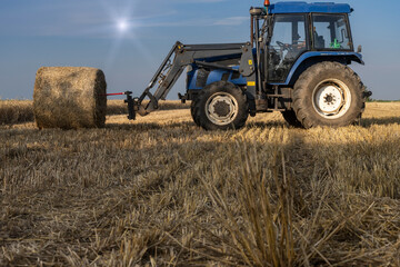 Fototapeta na wymiar Agriculture straw wagon in field