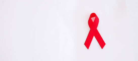 Red Ribbon for supporting people living and illness. Healthcare and safe sex concept. December World Aids Day Awareness month