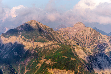 The meadows, the views and the peaks of the orobie alps during a summer afternoon, near the San Marco pass, Lombardy, Italy - June 2020