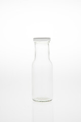 Isolated glass bottle on white background without cap.