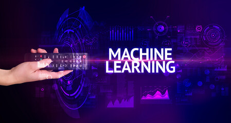 hand holding wireless peripheral with MACHINE LEARNING inscription, modern technology concept