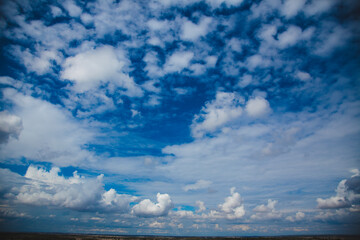 blue and white sky bright Sunny clouds contrasting photo background