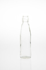 Isolated glass bottle on white background without cap.